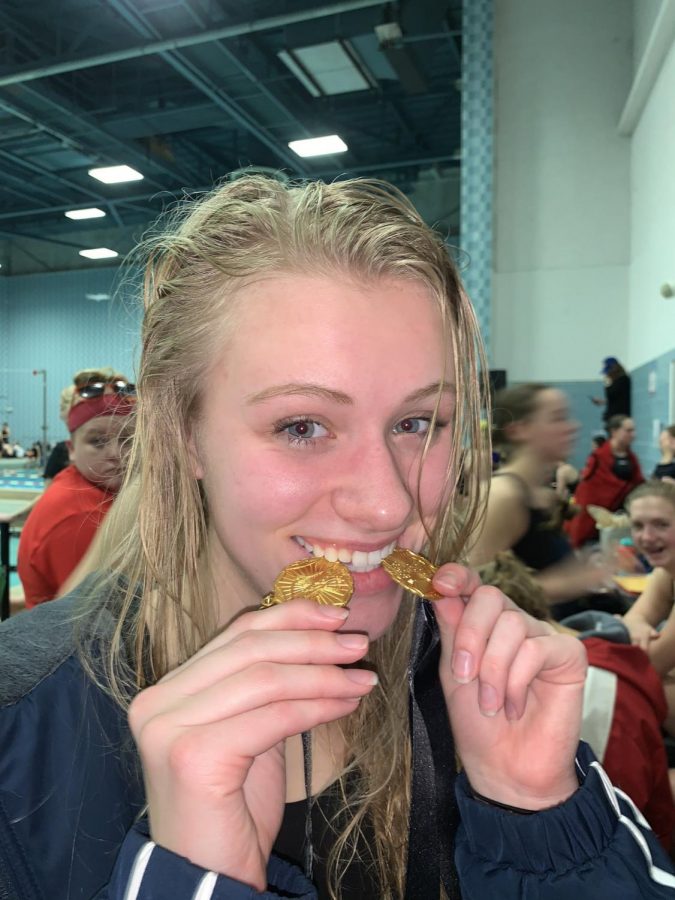 Lasecki+bites+both+of+her+gold+medals+after+winning+the+200+IM+and+the+100+fly.+Photo+by+%40bpgirlsswimming+on+twitter