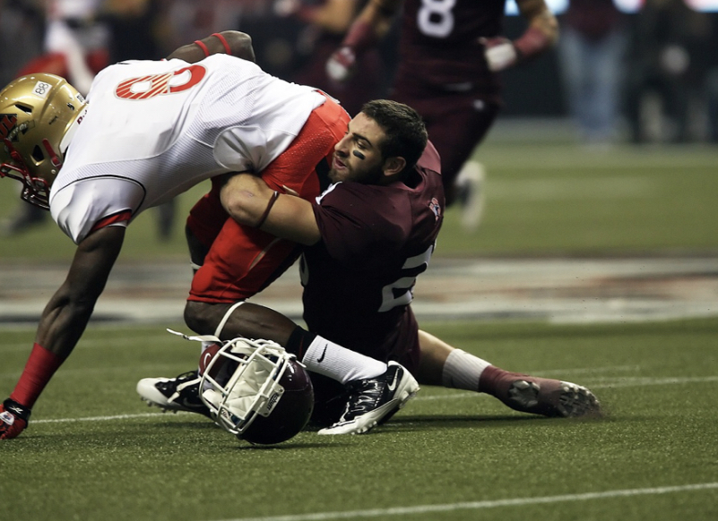 Canadian football player attempts a tackle during their game. Concussions have been proven to be most common in football and leave an added risk to the sport. Photo from Photo by Pixaby